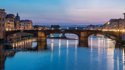 Ponte Santa Trinita Holy Trinity Bridge day to night timelapse over River Arno in Florence