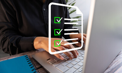 Businesswoman working on her computer and a virtual icon of a to-do list with a check mark