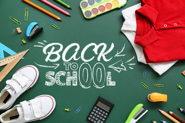 Frame made of stylish school uniform and different stationery on green chalkboard