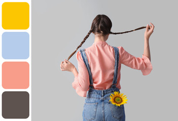 Young woman with beautiful sunflower on grey background, back view