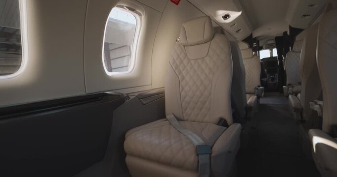 Elegant interior view of empty private jet cabin with luxurious leather seats