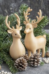 Two charming wooden reindeer figurines adorned with antlers, surrounded by pinecones and evergreen branches, creating a warm, festive atmosphere perfect for the holiday season.