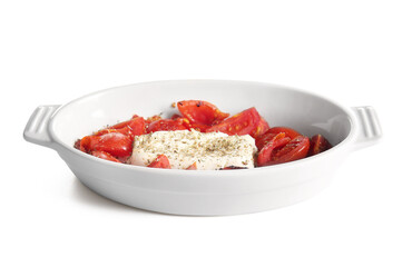 Baking dish with tasty tomatoes and feta cheese isolated on white background