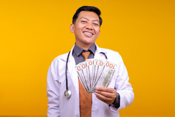 Asian male Physician With Lab Coat smiling While Holding Money
