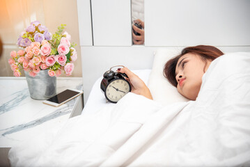 Asian women sleep wake up in white cozy bedroom happy time morning sunrise. Beautiful chinese use...