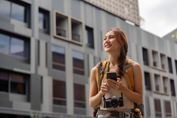 Traveling Woman Using Smartphone in City