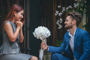 Surprise proposal young couple lover boyfriend give flower Bouquet to beautiful girlfriend to will...