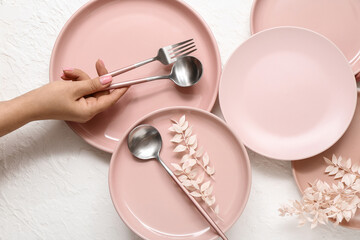 Female hand with beautiful table setting on white background