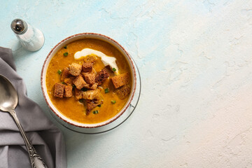 Bowl of tasty cream soup with croutons on white background