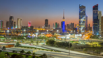 Naklejka premium Skyline with Skyscrapers day to night timelapse in Kuwait City downtown illuminated at dusk. Kuwait City, Middle East