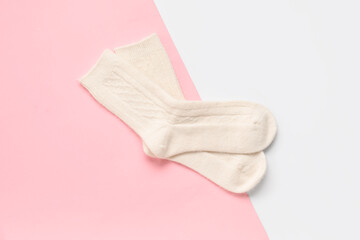 Warm socks on color background