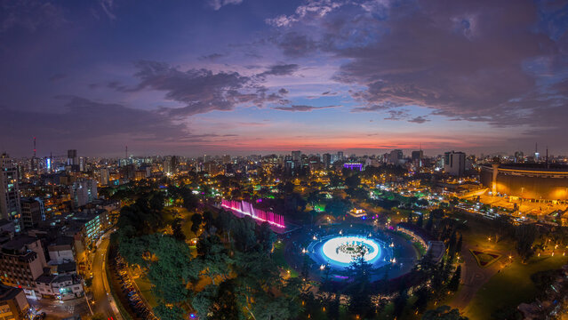 Aerial view to Park of the Reserve with magic water circuit biggest fountain complex day to night timelapse - Powered by Adobe