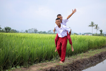 Indonesian Students In Uniform Playing Together Showing Friendship And Happiness