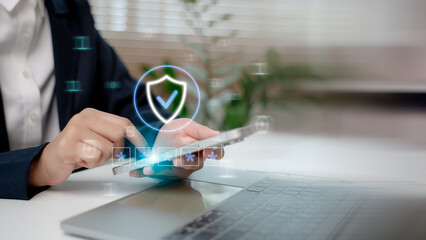 Business person using smartphone for secure login with shield icon, representing cybersecurity, data protection, password authentication, and mobile security access.