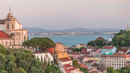 Tourists at the viewpoint Miradouro da Graca look at Lisbon overview aerial timelapse. Portugal