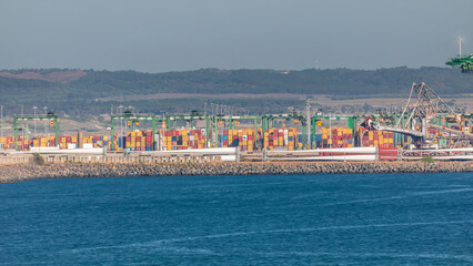 Fototapeta premium Aerial view of container cargo terminal of commercial port timelapse, business logistics and transport industry in Sines, Portugal.