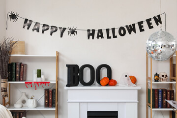 Disco ball and Halloween decorations on fireplace near white wall at home