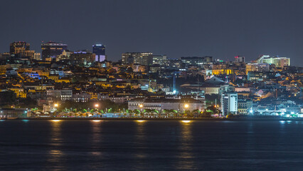Obraz premium Aerial night timelapse of Lisbon skyline with illuminated Amoreiras towers, Santos district