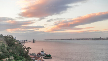 Obraz premium Aerial timelapse from a hill near Porto Brandao Ferry Station on the Tagus River in Lisbon