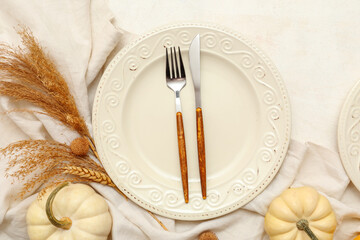 Beautiful table setting with fresh pumpkins and wheat on white background