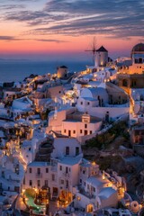 Sunset over a picturesque, cliffside village of whitewashed buildings, illuminated at dusk, with windmills silhouetted against a vibrant sky and calm sea