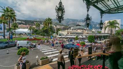 Tourists make pictures near expensive cars and famous Casino building timelapse in Monte Carlo in...