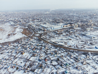 Snowy aerial panorama of Uralsk city in Kazakhstan with residential and industrial zones. c.