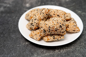 Phuket taro sesame puff pastry (Mor Lao), made from taro mixed with rice flour, sprinkled with sesame, on table top view.