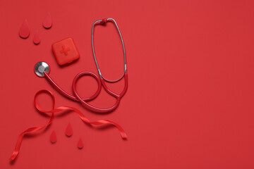 Red ribbon with drops, pill box and stethoscope on color background. Blood Cancer Awareness Month
