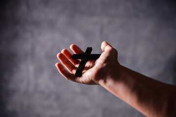 Christian woman lifts her hand in worship to pray, hope, faith, and deep belief in God defines core...