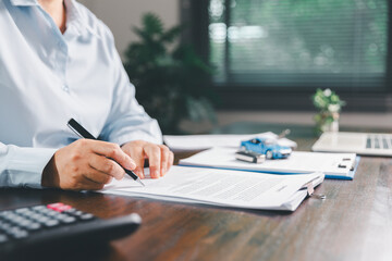 Customer signing insurance document lease agreement table, writing signature contract buying...