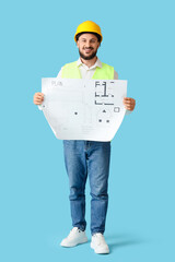Male architect with house plan on blue background