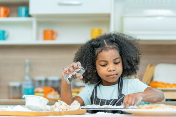 african afro black daughter kids sifting flour powder and sprinkling ingredients on massaging dough...