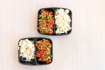 Fresh chopped chili and garlic in mini black dip bowl for add sukiyaki dip sauce on wood table