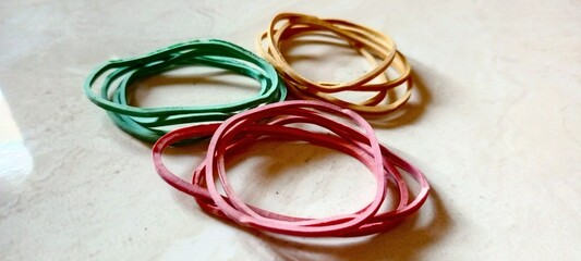 Photo of rubber bands in red, yellow, and green.