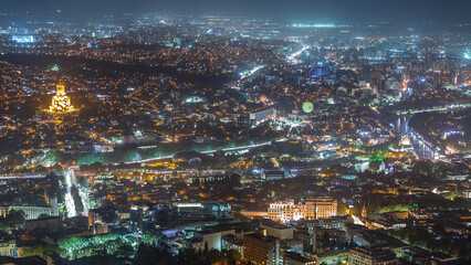 Holy Trinity Cathedral of Tbilisi, the Ceremonial Palace of Georgia and concert hall in Rike Park aerial night timelapse.