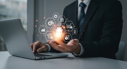 Businessman using laptop, holding digital house icon