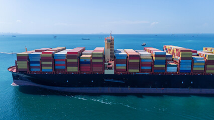 Aerial of cargo ship carrying container  for export cargo from cargo yard port to other ocean...