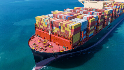 Aerial of cargo ship carrying container  for export cargo from cargo yard port to other ocean...
