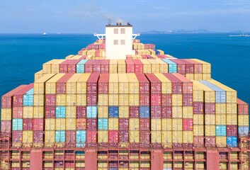 Aerial of cargo ship carrying container  for export cargo from cargo yard port to other ocean...