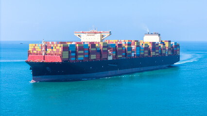 Aerial of cargo ship carrying container  for export cargo from cargo yard port to other ocean...