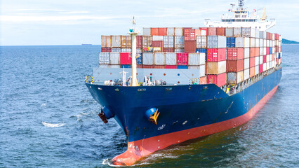 Aerial of cargo ship carrying container  for export cargo from cargo yard port to other ocean...