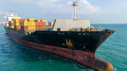 Aerial of cargo ship carrying container export cargo from cargo yard port to other ocean concept...