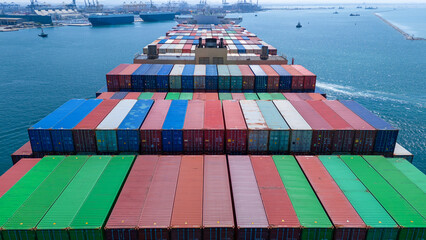 Aerial of cargo ship carrying container  for export cargo from cargo yard port to other ocean...