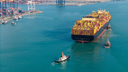 Aerial of cargo ship carrying container export cargo from cargo yard port to other ocean concept...