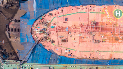 cargo container ship at dry dock concept maintenance service working in the sea. Insurance and...