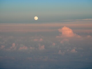 Full Moon Rising over Layered Clouds at Dusk, Viewed from Airplane above Japan