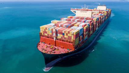 Fototapeta na wymiar Aerial of cargo ship carrying container for export cargo from cargo yard port to other ocean concept smart freight shipping ship front view