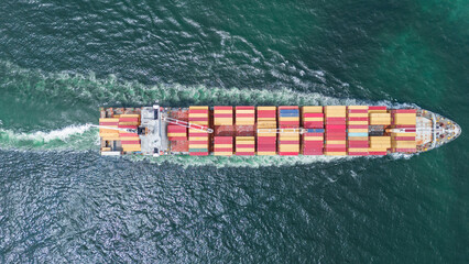 Aerial of cargo ship carrying container and running verry fast for export cargo from cargo yard...