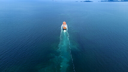 Aerial of cargo ship carrying container and running verry fast for export cargo from cargo yard...